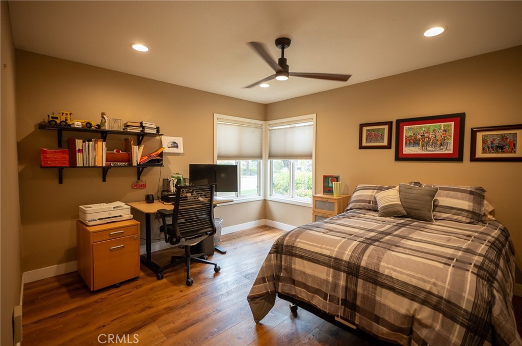 19 Windsong Irvine, CA 92614 - Photo 39 of 46 a spacious bedroom with a bed a couch and a chandelier