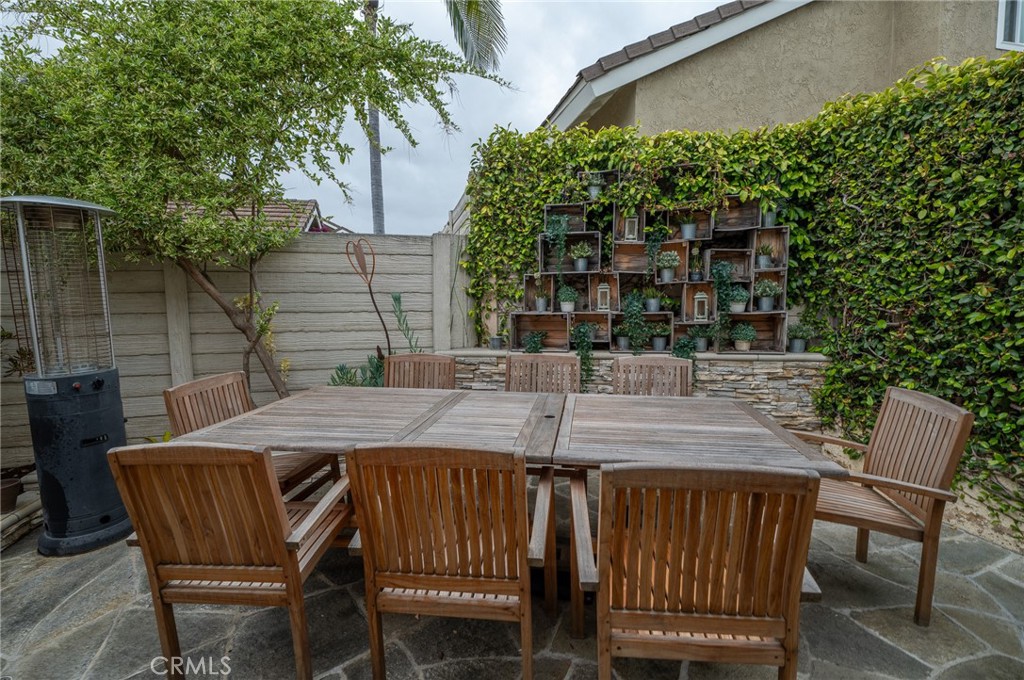 19 Windsong Irvine, CA 92614 - Photo 42 of 46 a patio with table and chairs and potted plants
