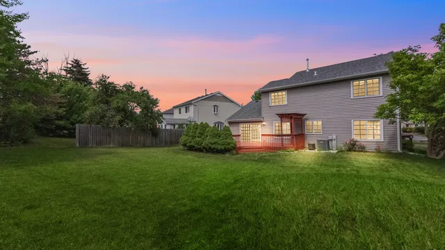 a front view of a house with a garden and yard