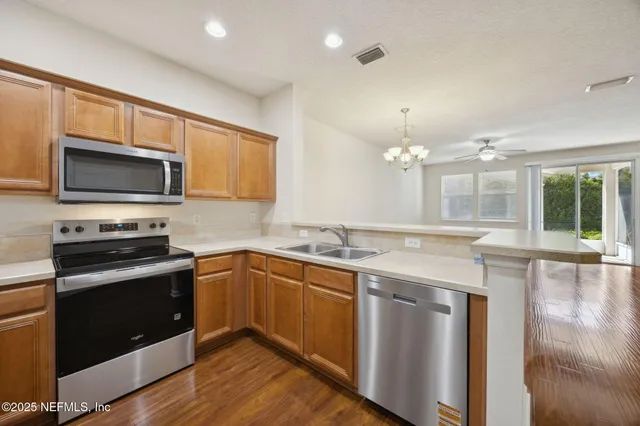 a kitchen with a sink stove and microwave