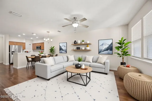 a living room with furniture and a chandelier