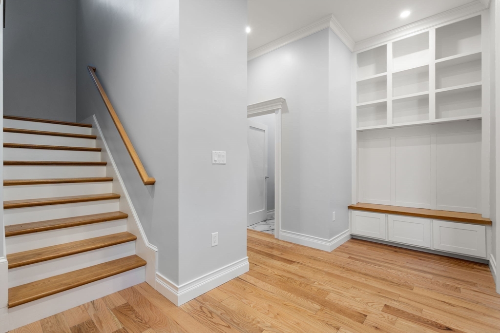 10 Hitching Post Lane Weston, MA 02493 - Photo 36 of 42 a view of an empty room with stairs and a wooden floor
