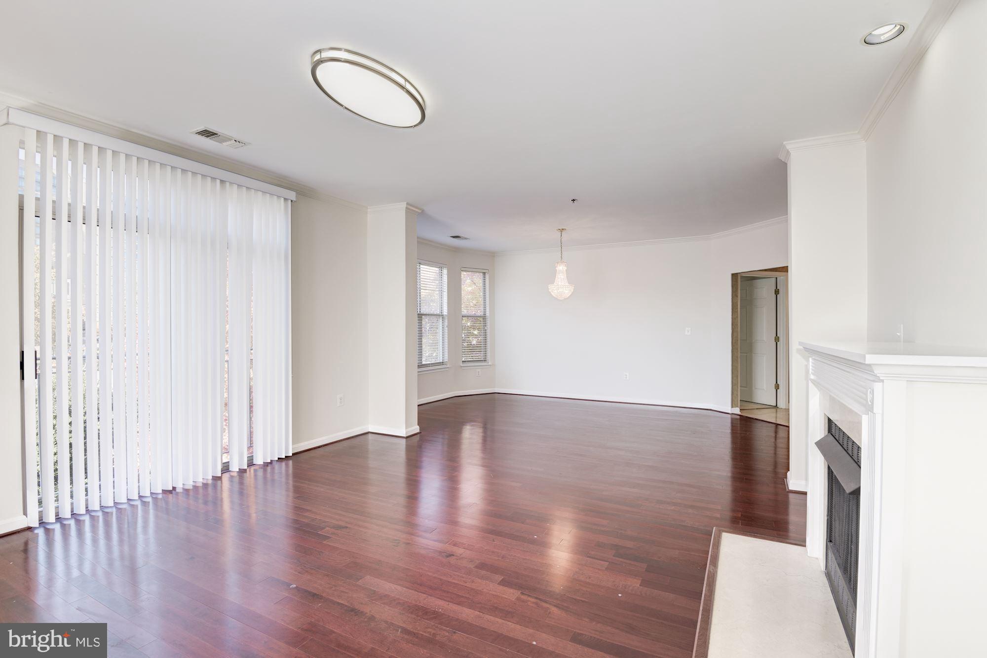 1860 Stratford Park Place, Unit 204 Reston, VA 20190 - Photo 12 of 41 a view of an empty room with wooden floor and window