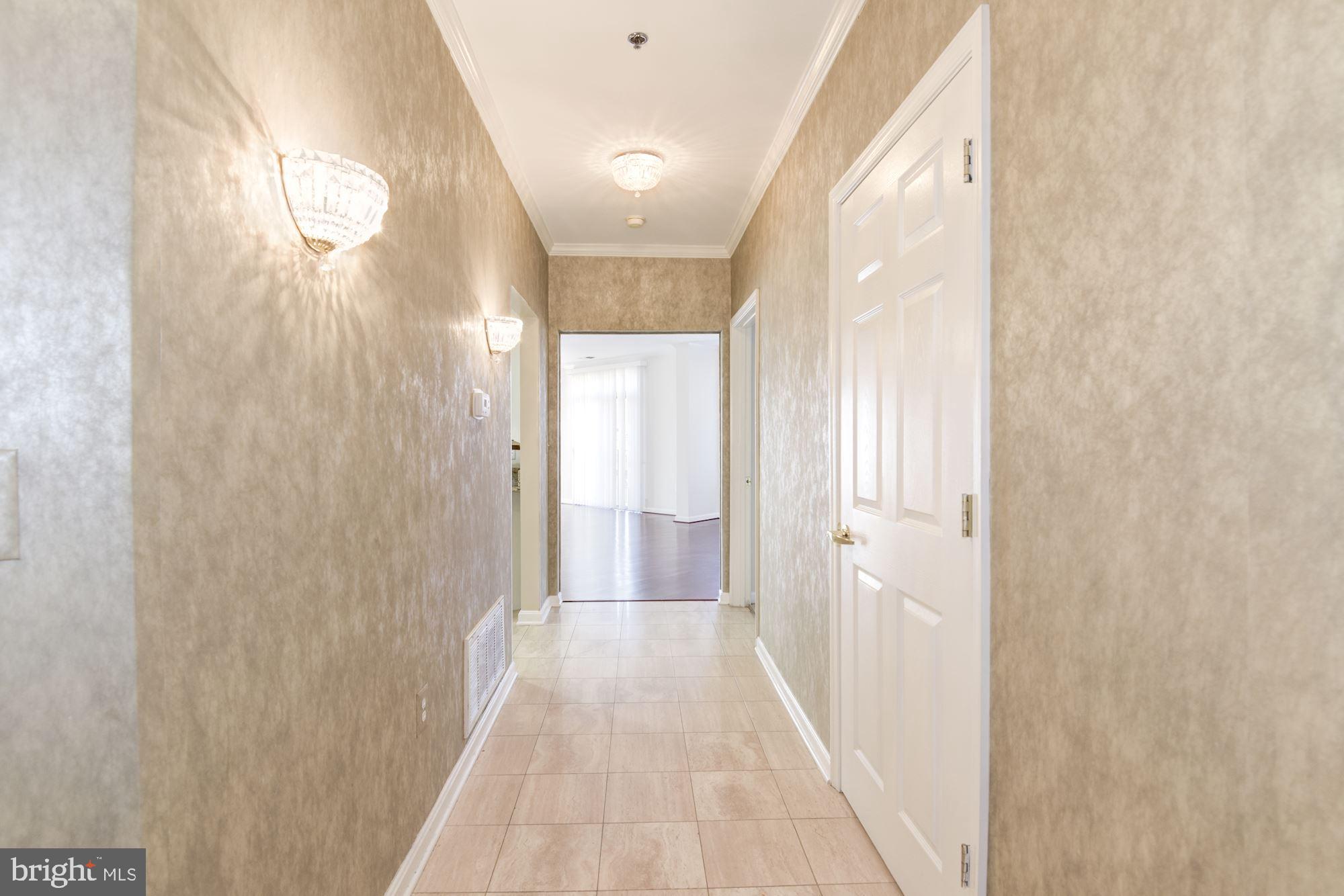 1860 Stratford Park Place, Unit 204 Reston, VA 20190 - Photo 2 of 41 a view of a bathroom from a hallway