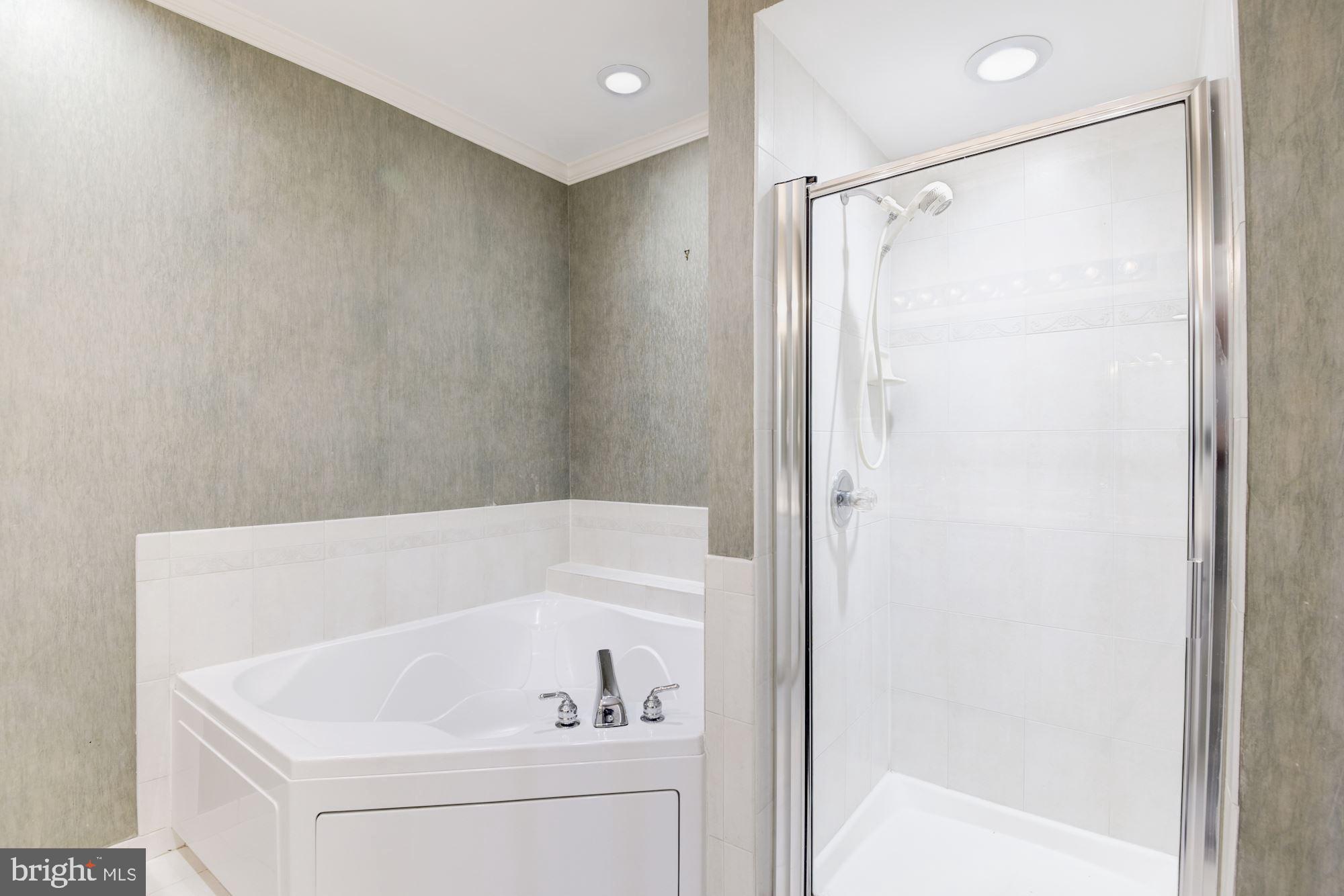 1860 Stratford Park Place, Unit 204 Reston, VA 20190 - Photo 25 of 41 a bathroom with a tub and a shower