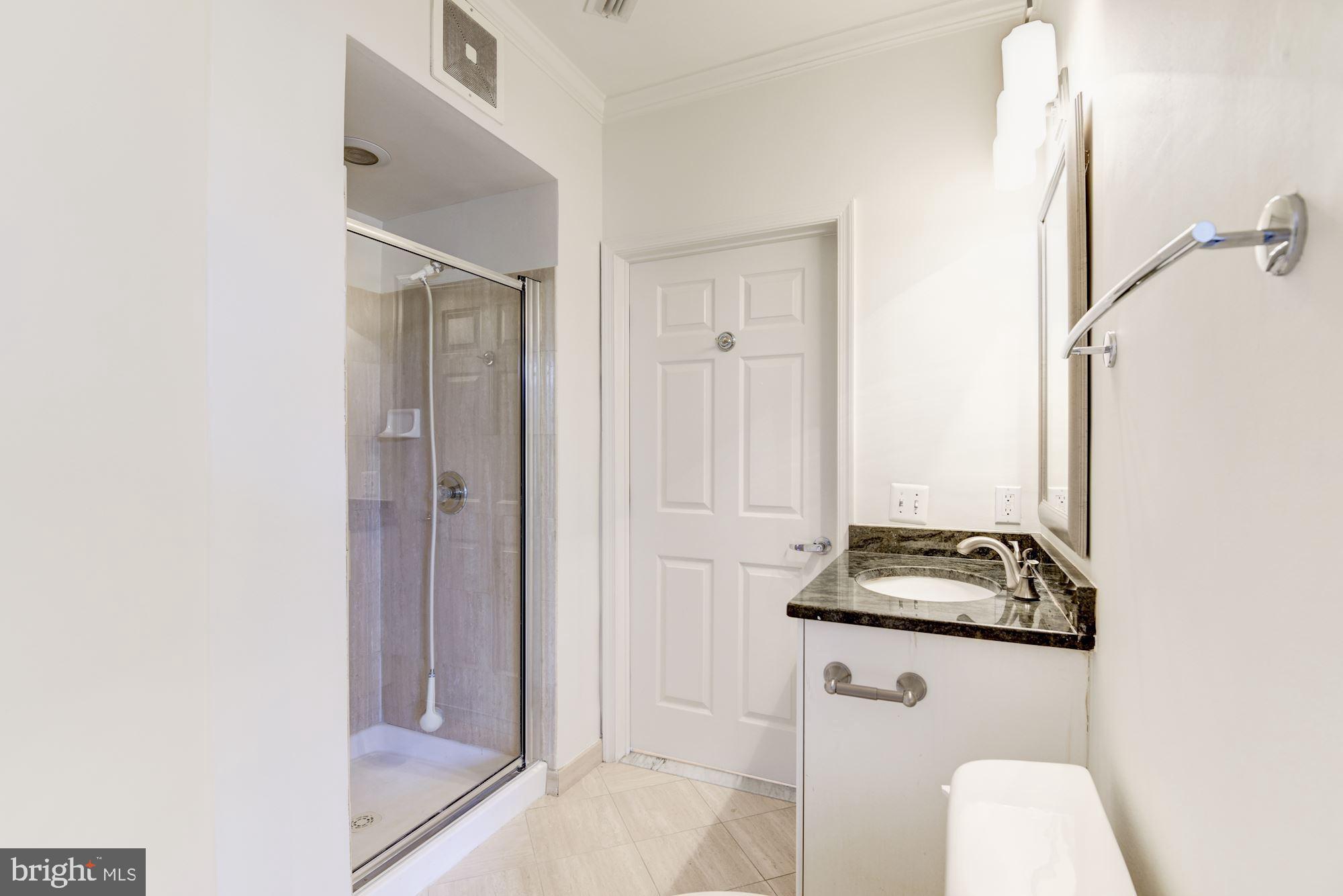 1860 Stratford Park Place, Unit 204 Reston, VA 20190 - Photo 30 of 41 a bathroom with a granite countertop sink and a mirror