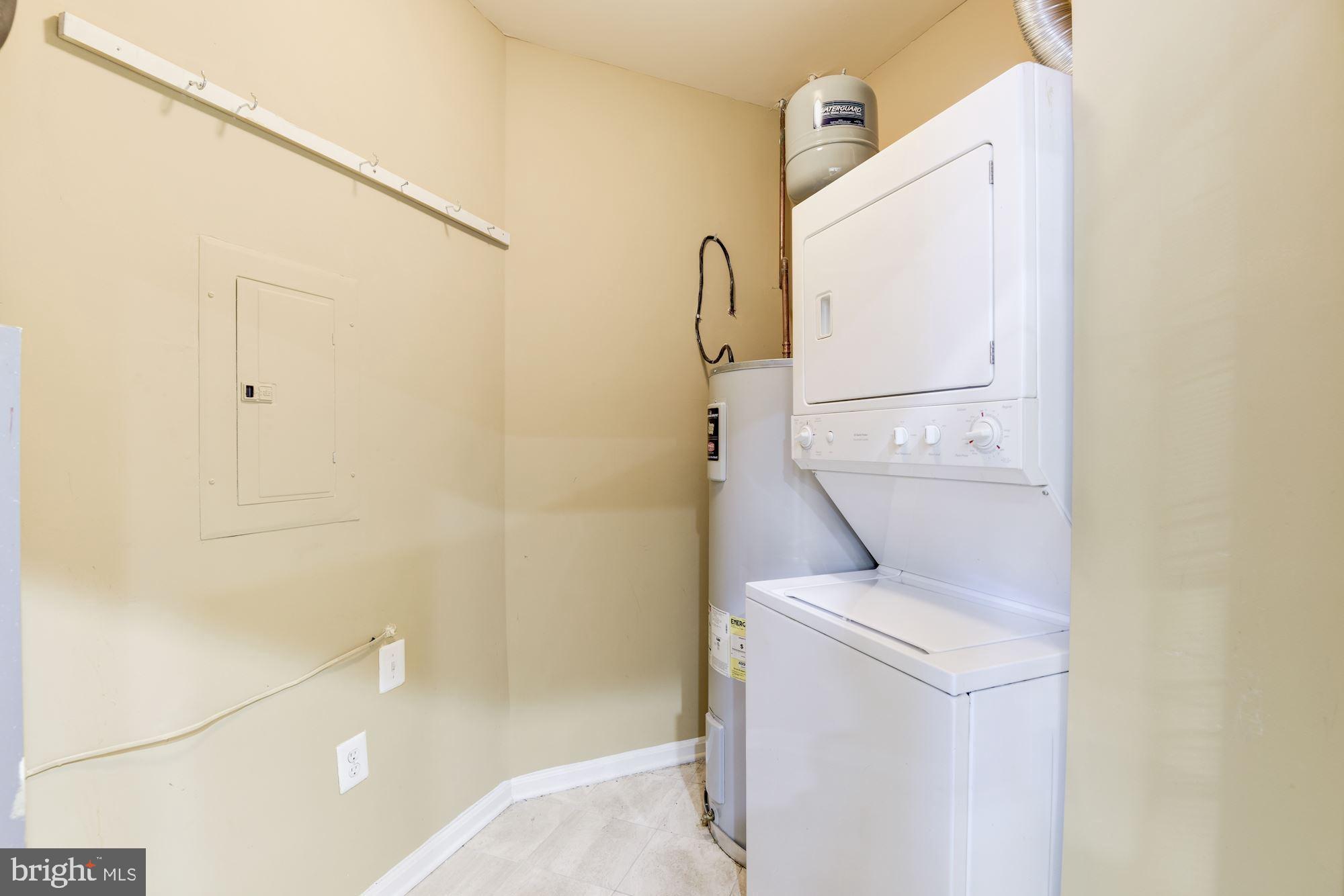 1860 Stratford Park Place, Unit 204 Reston, VA 20190 - Photo 32 of 41 a bathroom with a sink and washing machine