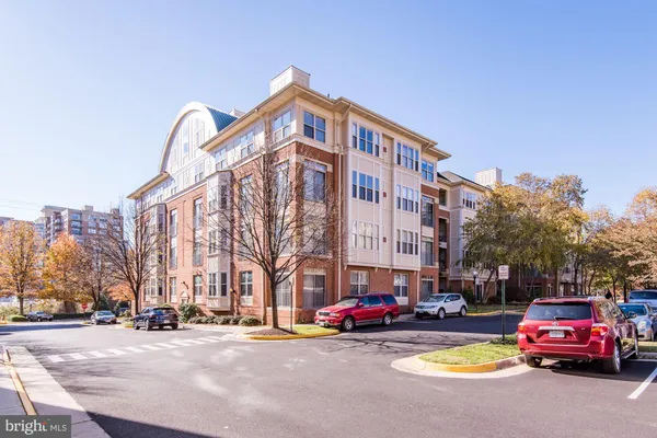 a view of a cars is parked in front of a building