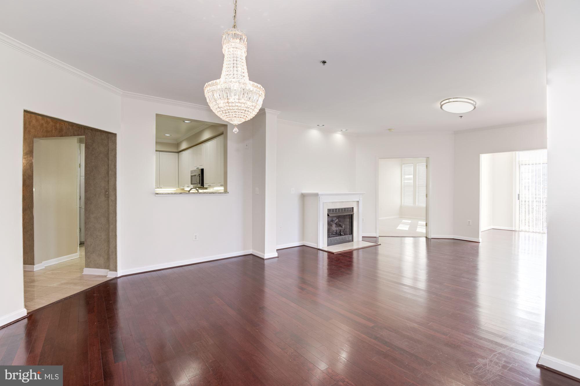 1860 Stratford Park Place, Unit 204 Reston, VA 20190 - Photo 7 of 41 a view of an empty room with wooden floor and a window