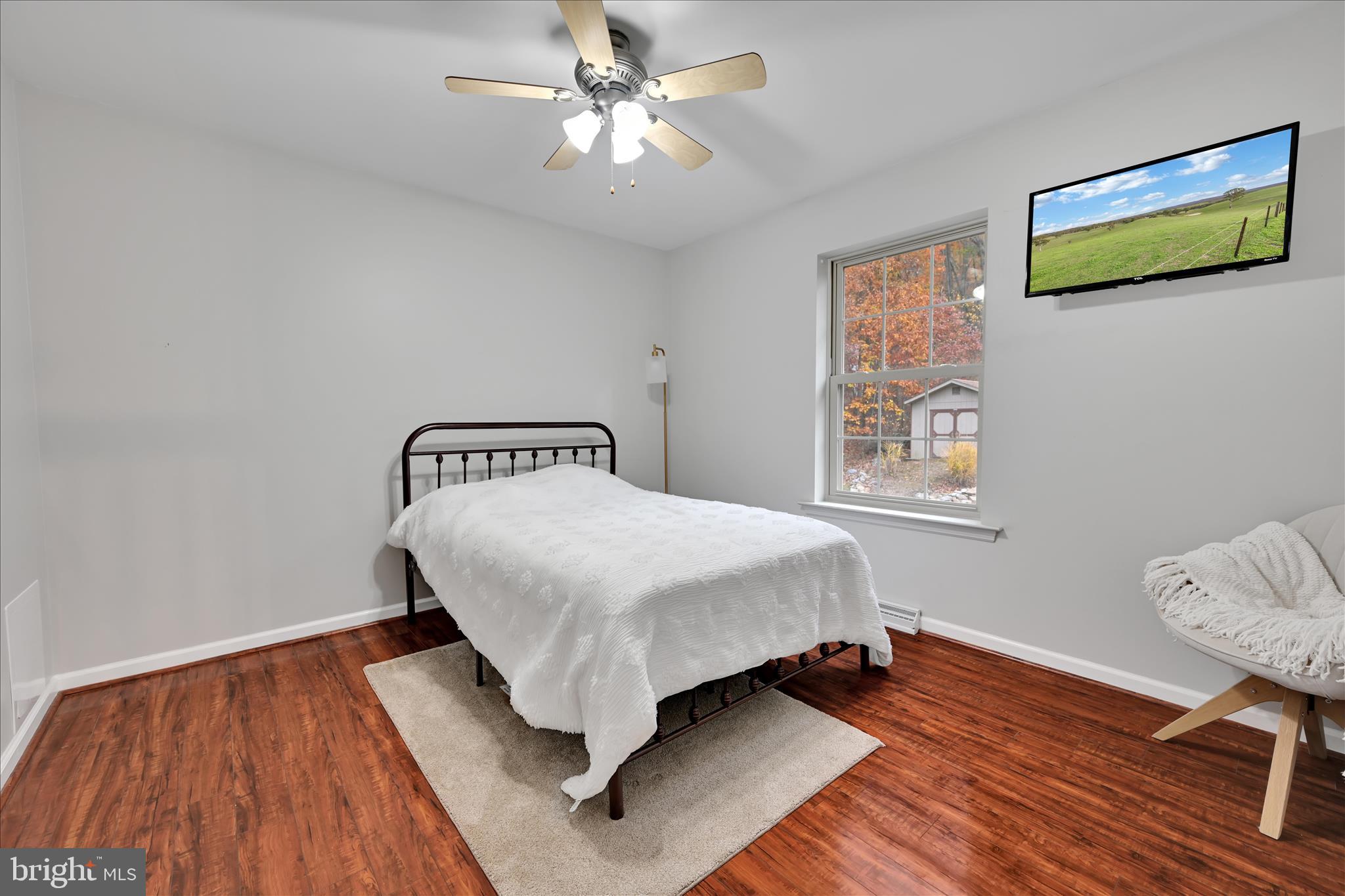 604 Airport Road Ashland, PA 17921 - Photo 23 of 37 a bedroom with a bed and wooden floor