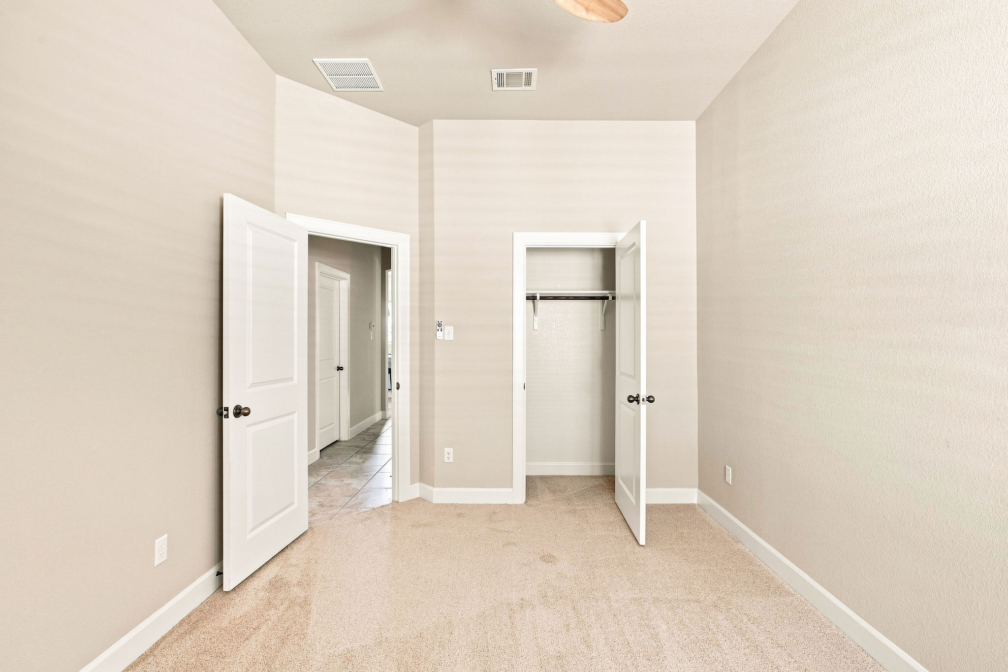 6100 Gunnison Turn Road Austin, TX 78738 - Photo 12 of 34 Soft carpeting pairs with neutral walls in this comfortable secondary bedroom.