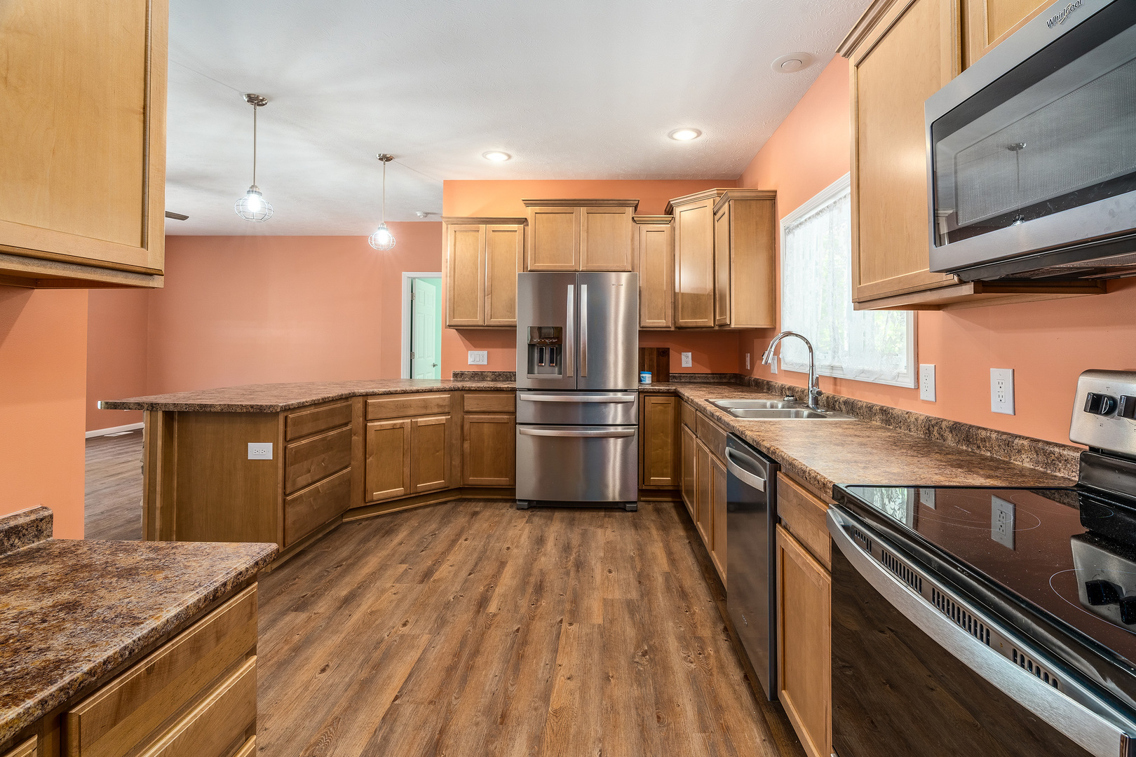 18562 East Hill Street Mount Vernon, IL 62864 - Photo 12 of 43 a kitchen with stainless steel appliances granite countertop a sink a stove and a refrigerator
