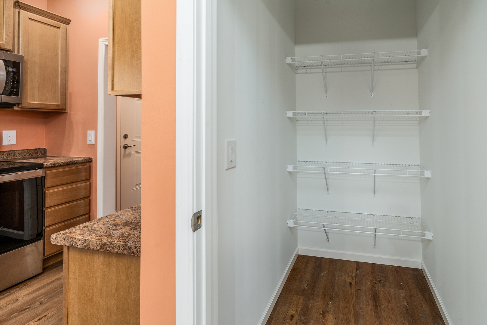 18562 East Hill Street Mount Vernon, IL 62864 - Photo 14 of 43 a view of a kitchen with white cabinets and wooden floor