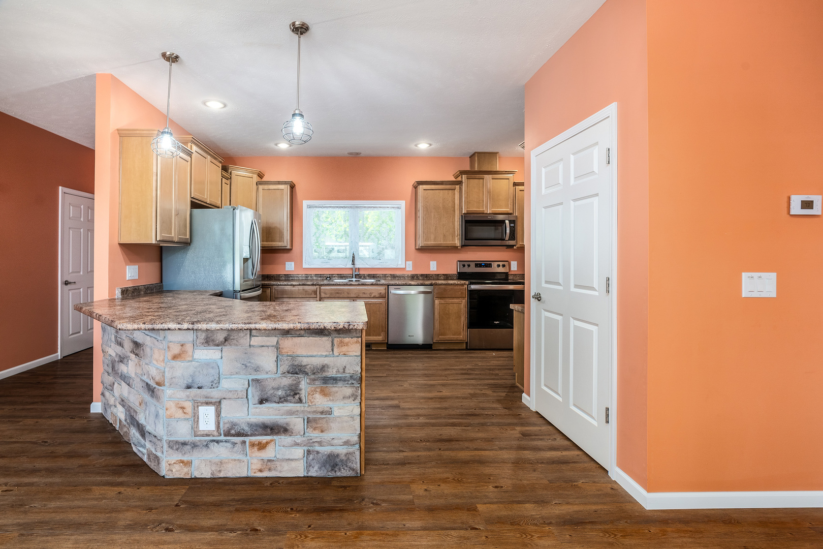 18562 East Hill Street Mount Vernon, IL 62864 - Photo 8 of 43 a kitchen with kitchen island a counter top space a sink stainless steel appliances and cabinets
