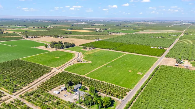 a view of a golf course with a building in the background