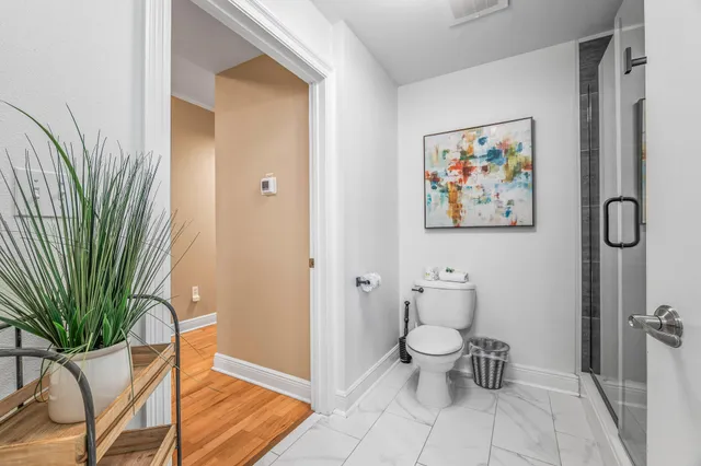 a bathroom with a toilet and a shower curtain