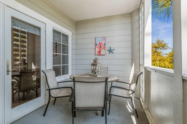 a table and chairs in a room next to a window