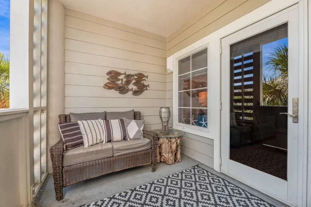 a white couch sitting in a living room next to a window