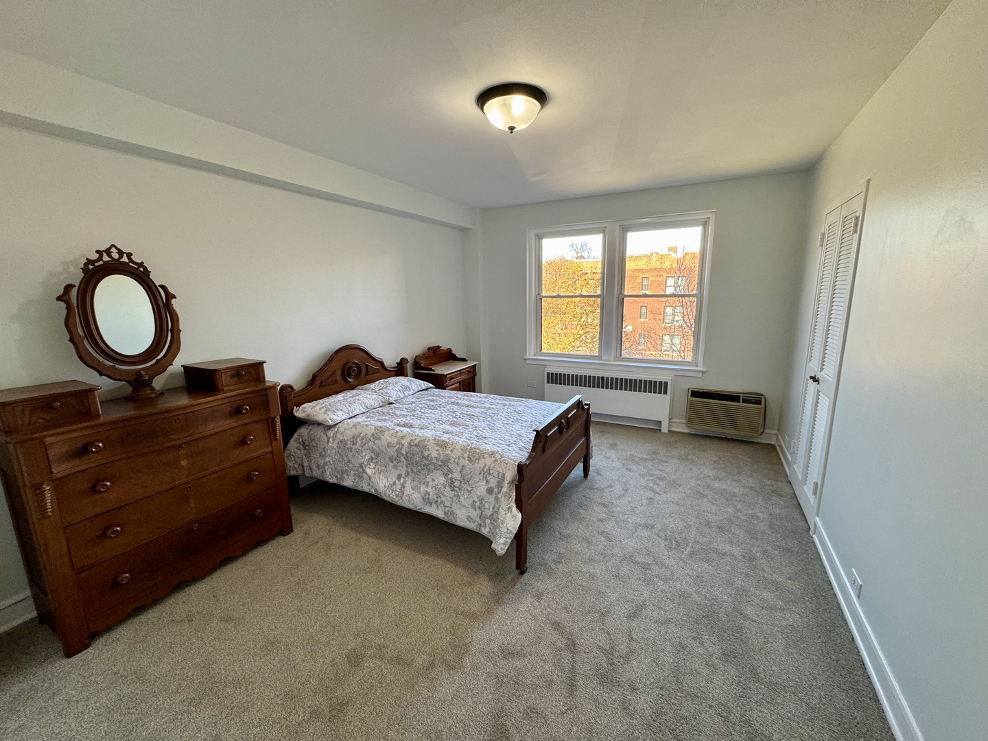 1585 Ridge Avenue, Unit 301 Evanston, IL 60201 - Photo 16 of 29 a spacious bedroom with a bed and window