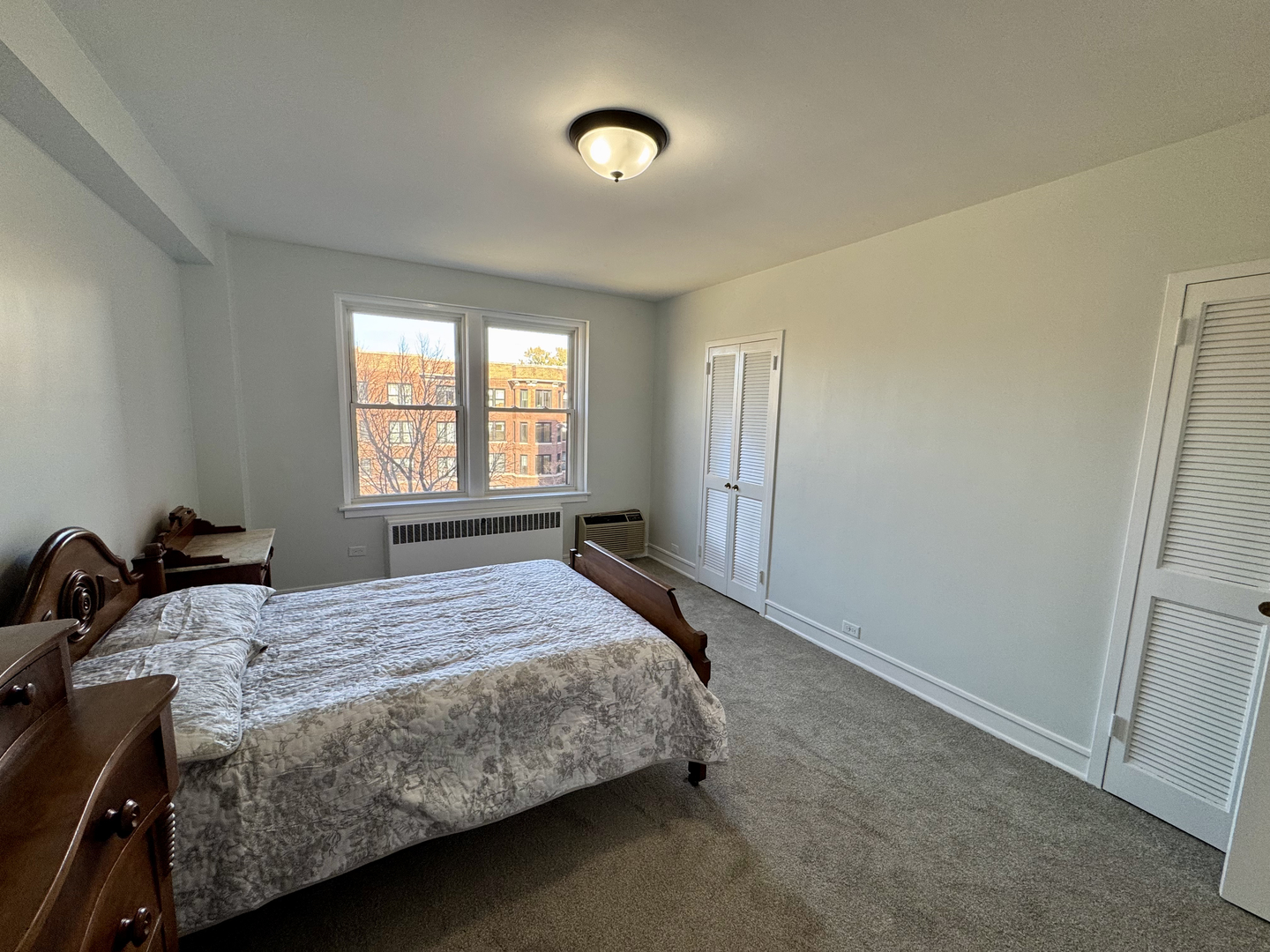 1585 Ridge Avenue, Unit 301 Evanston, IL 60201 - Photo 17 of 29 a bedroom with a bed and a window