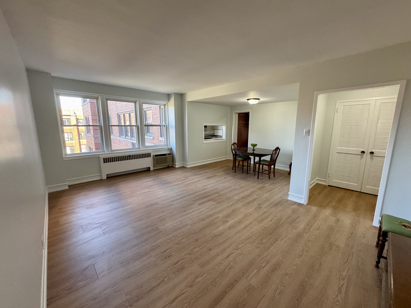 1585 Ridge Avenue, Unit 301 Evanston, IL 60201 - Photo 3 of 29 an empty room with wooden floor and a window