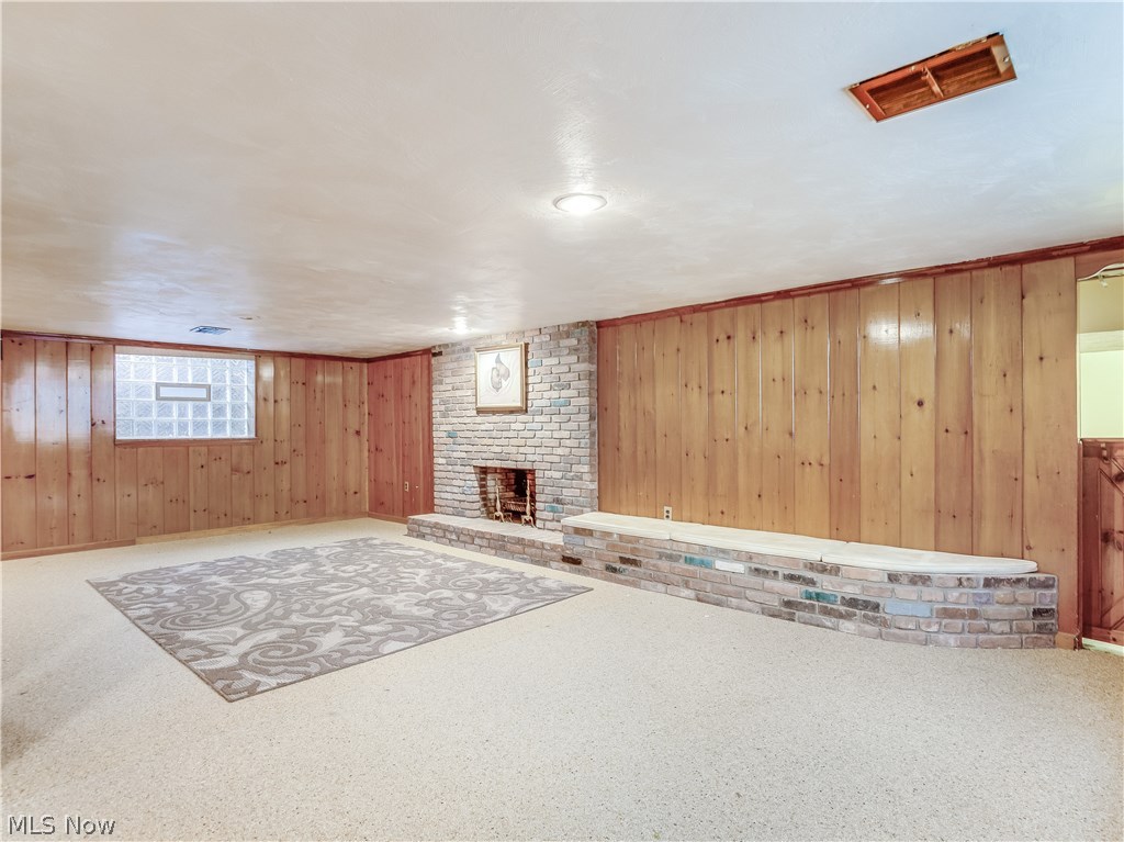 1072 Brandon Road Cleveland, OH 44112 - Photo 21 of 24 Finished Basement features Wood Burning Fireplace and Nature Stone Flooring.