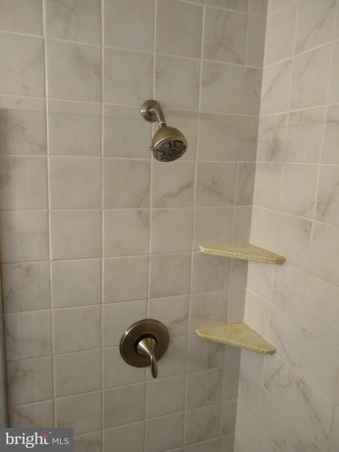 7404 Sudbrook Road Baltimore, MD 21208 - Photo 14 of 40 a bathroom with a shower