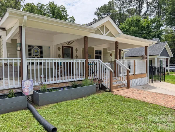 a view of a house with wooden deck and furniture