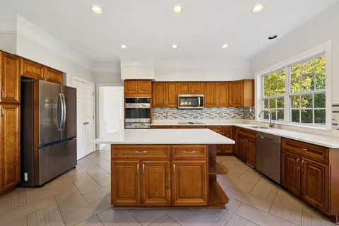 a view of empty room with wooden floor and fireplace