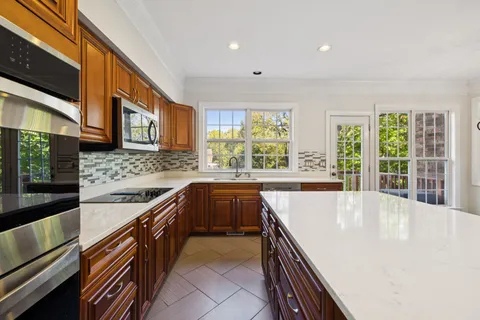 a view of a kitchen with microwave and a stove