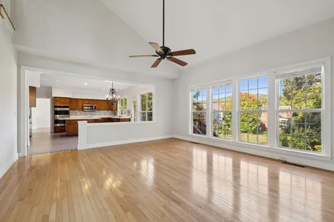 a large white bathroom with a double vanity sink a mirror and a bathtub
