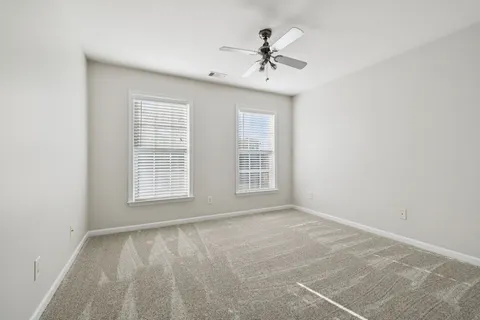 a room with pool table and windows