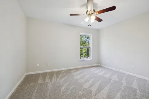 a view of a yard with wooden fence