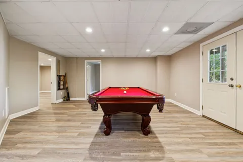 an aerial view of residential houses with outdoor space and trees