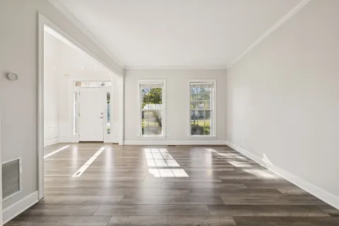 a large white kitchen with a large window