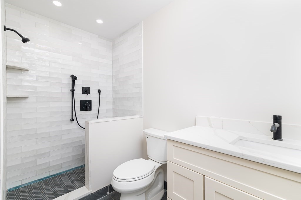 5 Pleasant Street, Unit 3 Hingham, MA 02043 - Photo 15 of 25 a bathroom with a sink a toilet and shower