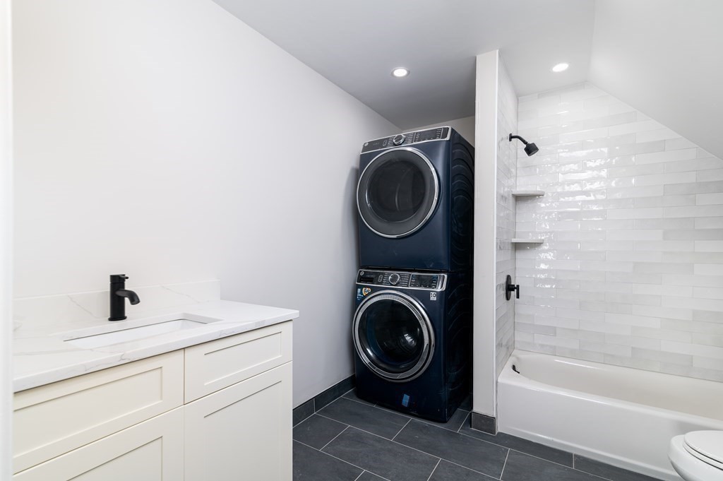 5 Pleasant Street, Unit 3 Hingham, MA 02043 - Photo 17 of 25 a bathroom with a sink a washer and dryer