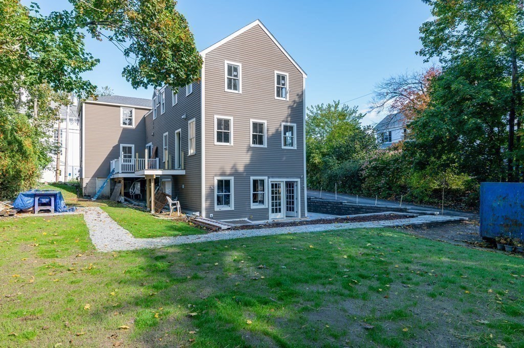 5 Pleasant Street, Unit 3 Hingham, MA 02043 - Photo 24 of 25 a front view of a house with a yard and trees