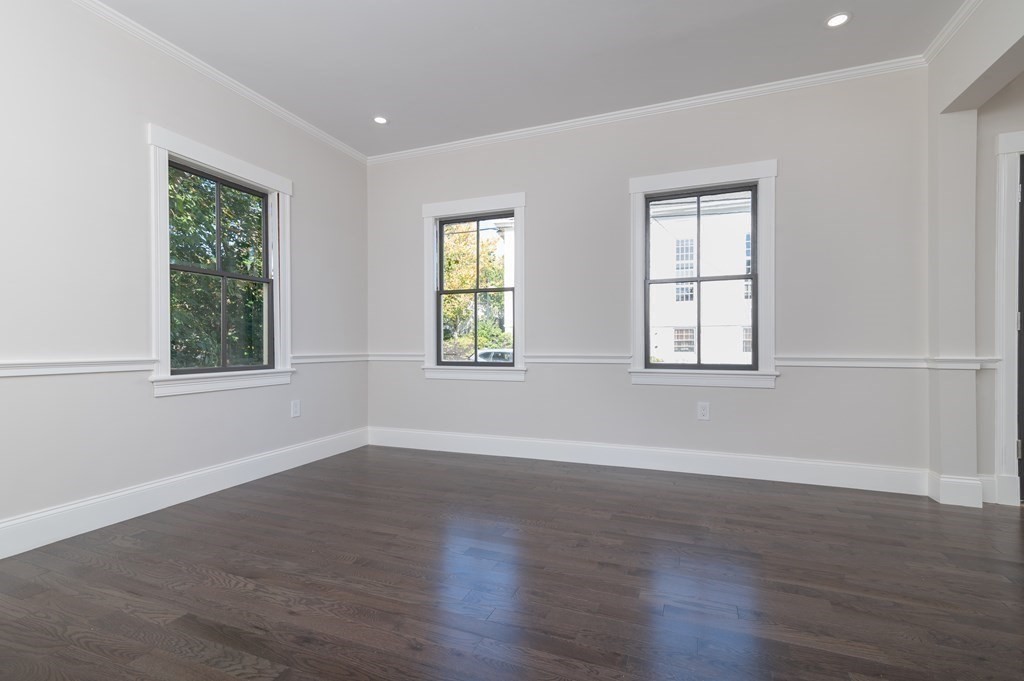 5 Pleasant Street, Unit 3 Hingham, MA 02043 - Photo 4 of 25 a view of an empty room with wooden floor and a window