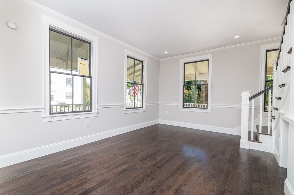 5 Pleasant Street, Unit 3 Hingham, MA 02043 - Photo 6 of 25 a view of an empty room with wooden floor and a window