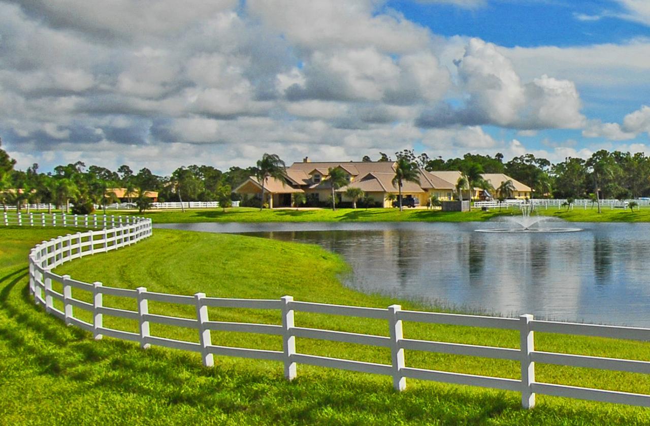 2300 Southeast Ranch Road South Jupiter, FL 33478 - Photo 1 of 44 a view of a lake with houses in the back