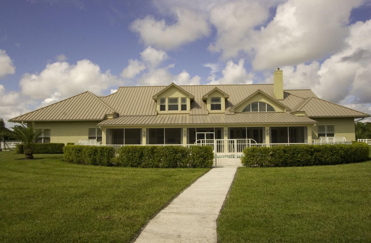2300 Southeast Ranch Road South Jupiter, FL 33478 - Photo 12 of 44 a front view of a house with a garden
