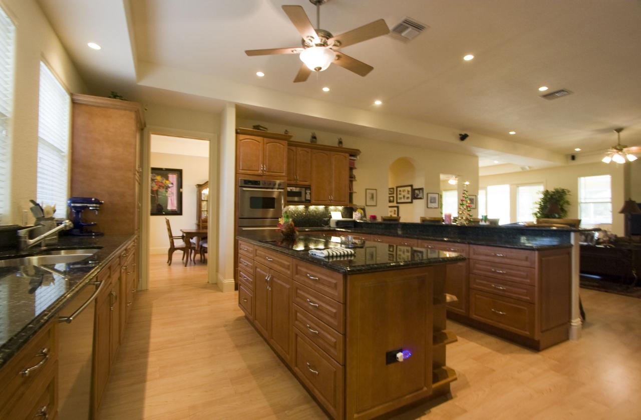 2300 Southeast Ranch Road South Jupiter, FL 33478 - Photo 18 of 44 a kitchen with stainless steel appliances granite countertop a sink a stove and a wooden floors