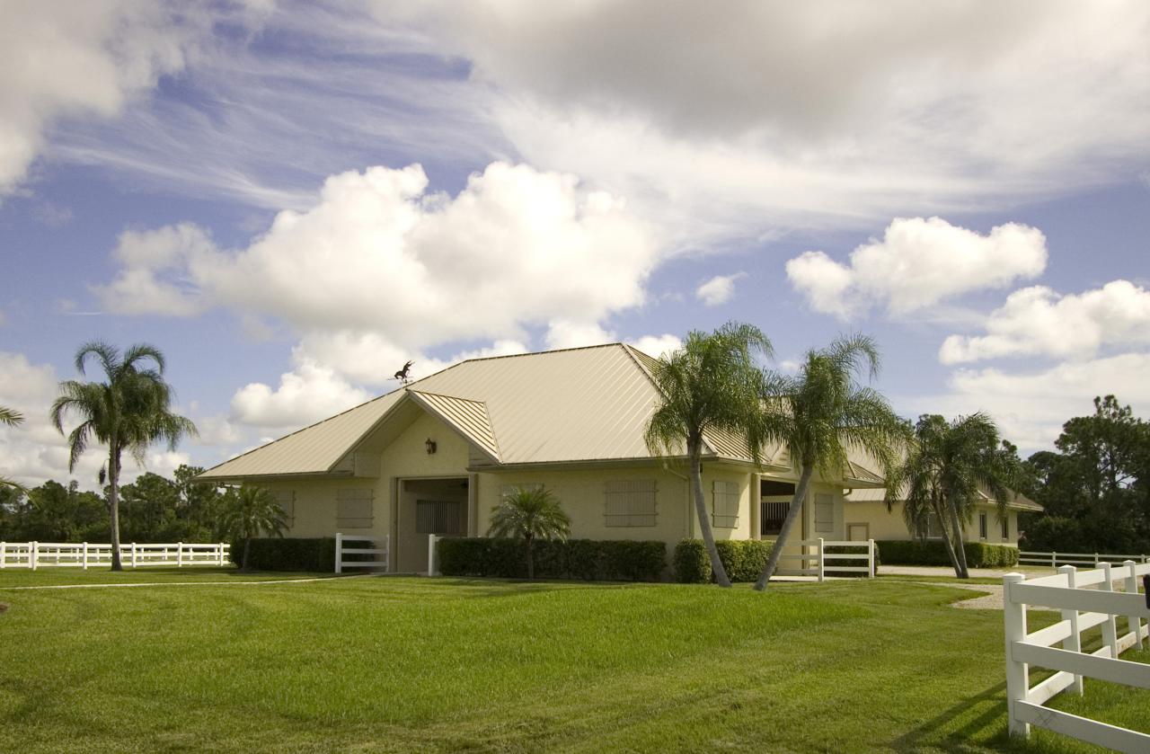 2300 Southeast Ranch Road South Jupiter, FL 33478 - Photo 5 of 44 a front view of a house with a garden and trees