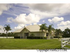 2300 Southeast Ranch Road South Jupiter, FL 33478 - Photo 42 of 44 a front view of a house with a garden