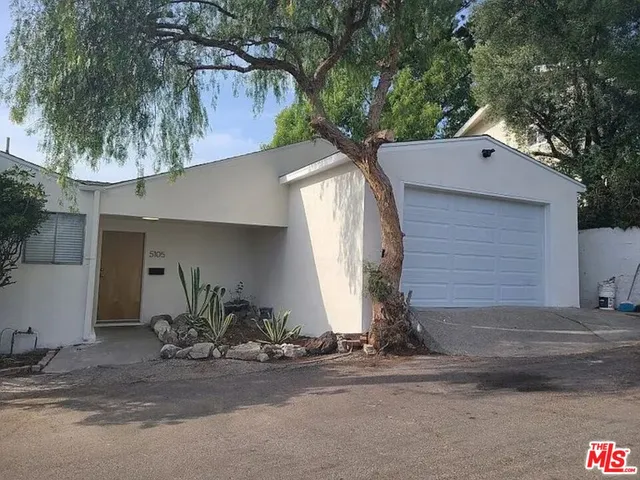 a front view of a house with yard