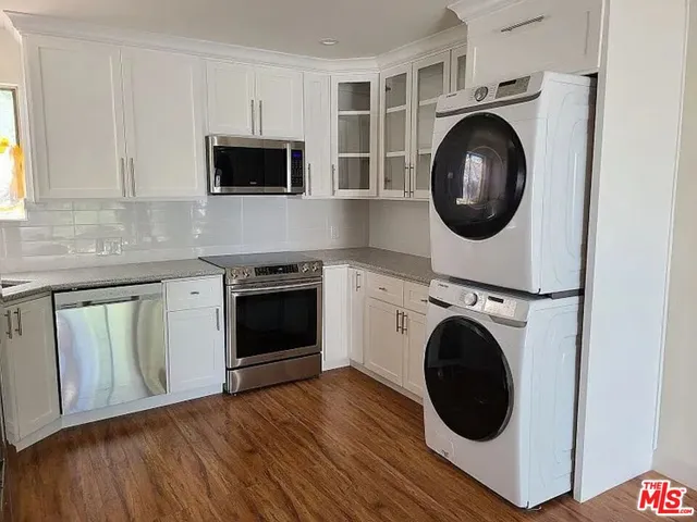 a kitchen with wooden cabinets and a microwave