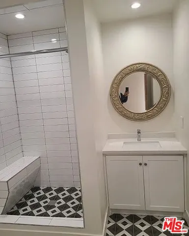 a bathroom with a sink a toilet and a shower