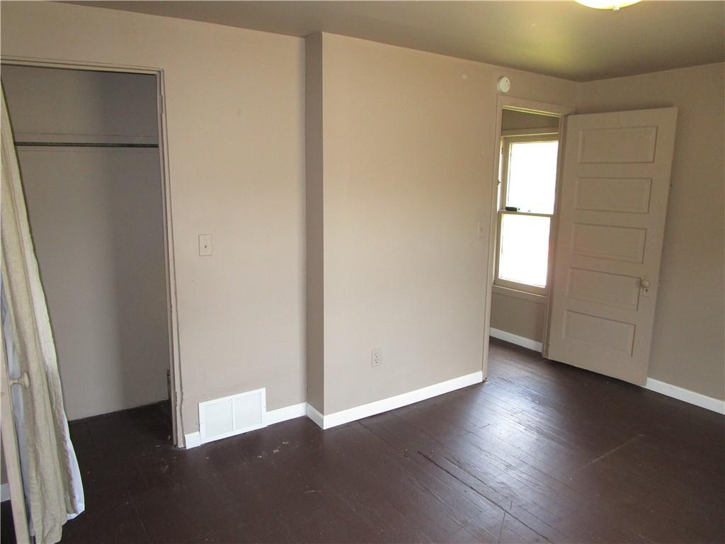 1124 Webster Street Farrell, PA 16121 - Photo 11 of 17 an empty room with wooden floor and windows