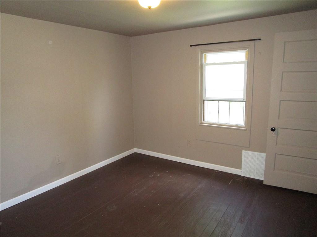 1124 Webster Street Farrell, PA 16121 - Photo 12 of 17 an empty room with wooden floor and windows